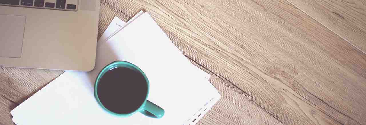 coffee cup, paper, laptop